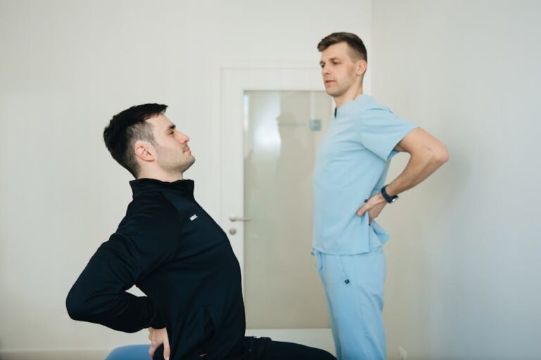 a physiotherapist instructs a patient on back exercises in a