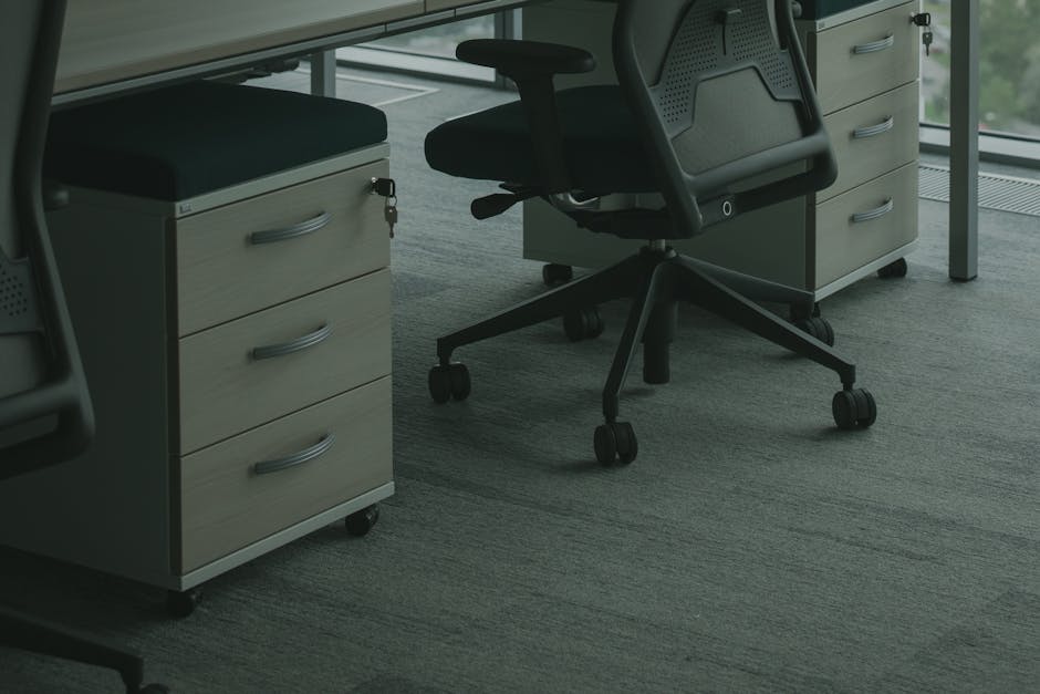A sleek office setup featuring ergonomic chairs and drawer units in a well-lit space.