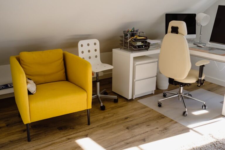 Bright home office with a yellow chair and organized desk setup.