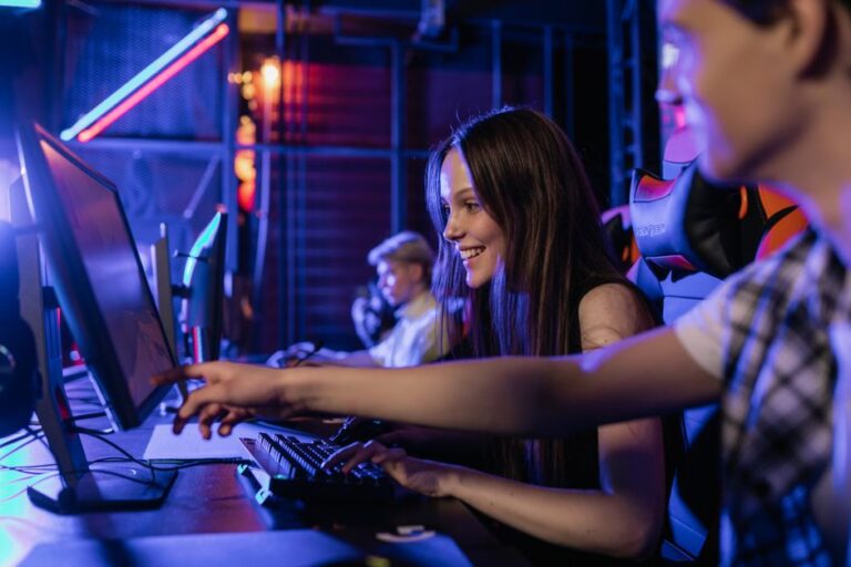 group of teenagers happily engaged in gaming at a computer s
