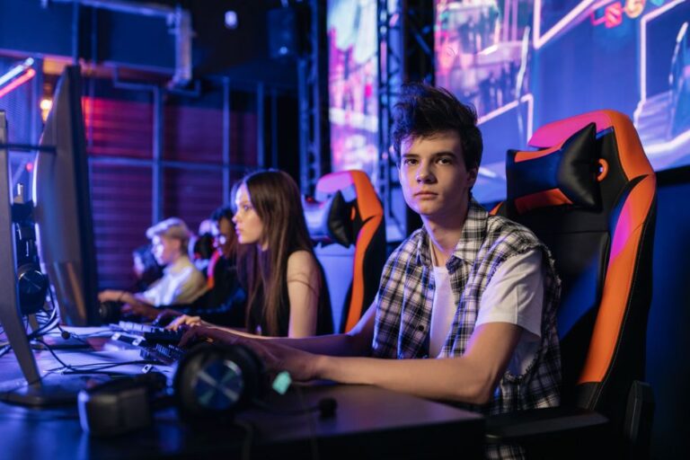 a group of teenagers intensely focused on a competitive gami