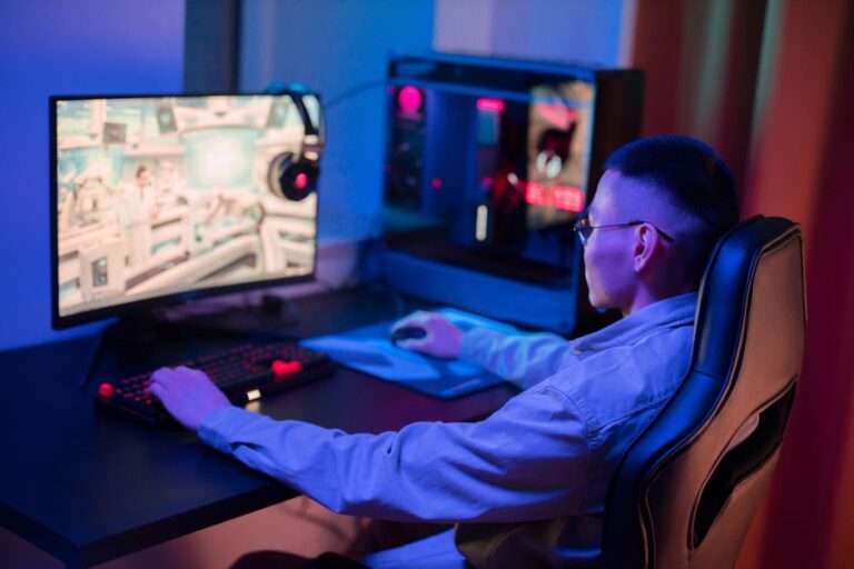 a young man intensely gaming on a computer at home showcasin